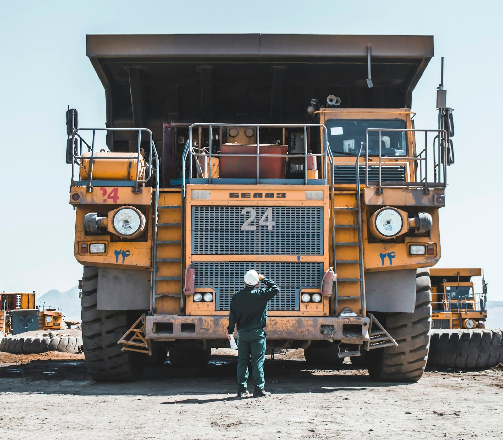 Mine worker beside a haul truck